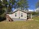 Exterior view features wooden steps, siding and a well maintained yard and lawn at 1938 Main Nw St, Atlanta, GA 30318