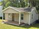 Newly renovated home featuring neutral siding, a welcoming porch, and well-maintained lawn at 1938 Main Nw St, Atlanta, GA 30318