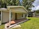 Charming home featuring a cozy porch and light beige siding, perfect for curb appeal at 1938 Main Nw St, Atlanta, GA 30318