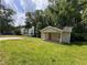 Charming bungalow-style home with a covered front porch and green lawn, surrounded by mature trees at 1938 Main Nw St, Atlanta, GA 30318