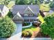 Aerial view showcasing landscaping and curb appeal of traditional two-story home at 2694 Dawning Day Dr, Dacula, GA 30019