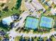 Aerial view of community pool and tennis courts surrounded by green spaces and parking at 2694 Dawning Day Dr, Dacula, GA 30019