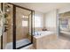 Bathroom featuring tiled shower and soaking tub at 2694 Dawning Day Dr, Dacula, GA 30019