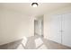 Simple bedroom with neutral walls and carpet with light streaming in from window at 2694 Dawning Day Dr, Dacula, GA 30019