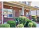Charming covered front porch with brick facade and neatly manicured bushes at 2694 Dawning Day Dr, Dacula, GA 30019