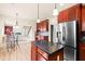 Open kitchen with a center island and stainless steel refrigerator with view of living area at 2694 Dawning Day Dr, Dacula, GA 30019