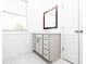 Bright bathroom features a modern vanity, window, and linen closet at 702 Dodd Ln # 159, Buford, GA 30518