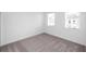 Bedroom with neutral carpet, white walls, base trim, and window at 702 Dodd Ln # 159, Buford, GA 30518