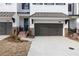 Beautiful new townhome showing garage and entrance with brick and concrete driveway at 702 Dodd Ln # 159, Buford, GA 30518