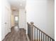 Hallway landing featuring wood-look floors and black iron railings at 702 Dodd Ln # 159, Buford, GA 30518