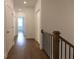 Hallway with hardwood floors, white walls, and white doors leading to other rooms in the house at 702 Dodd Ln # 159, Buford, GA 30518