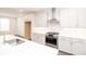 Modern kitchen featuring white cabinets, stainless steel appliances, and a sleek marble countertop at 702 Dodd Ln # 159, Buford, GA 30518