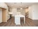 Bright kitchen featuring white cabinets, stainless steel appliances, and a large island with a marble countertop at 702 Dodd Ln # 159, Buford, GA 30518