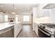 Modern kitchen featuring white cabinets, stainless steel appliances, and a large island with a sleek countertop at 702 Dodd Ln # 159, Buford, GA 30518