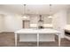 Bright kitchen featuring white cabinets, stainless steel appliances, and a large island with a marble countertop at 702 Dodd Ln # 159, Buford, GA 30518