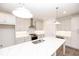 Bright kitchen featuring white cabinets, stainless steel appliances, and a large island with a marble countertop at 702 Dodd Ln # 159, Buford, GA 30518