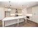 Bright kitchen featuring white cabinets, stainless steel appliances, and a large island with a marble countertop at 702 Dodd Ln # 159, Buford, GA 30518