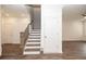 Open stairway leading to living room and bedroom area with beautiful flooring at 702 Dodd Ln # 159, Buford, GA 30518