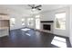 Bright living room with a stone fireplace, ceiling fan, and ample natural light at 702 Dodd Ln # 159, Buford, GA 30518