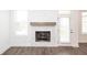 A fireplace with a wood mantle in living room featuring wood-look floors at 702 Dodd Ln # 159, Buford, GA 30518