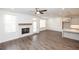 A spacious living room featuring wood-look floors, a fireplace, and a kitchen view at 702 Dodd Ln # 159, Buford, GA 30518