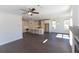 Open-concept living room and kitchen with white walls and dark hardwood floors at 702 Dodd Ln # 159, Buford, GA 30518