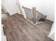 Staircase landing featuring wood-look floors and black iron railings at 702 Dodd Ln # 159, Buford, GA 30518