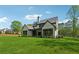 Back exterior view of home with a large, green, well-manicured lawn at 100 Maison Ct, Roswell, GA 30076