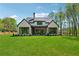 Expansive backyard features a covered patio with an outdoor seating area and fireplace at 100 Maison Ct, Roswell, GA 30076