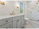 Bathroom with grey vanity, white countertop, gold hardware, and a glass shower at 100 Maison Ct, Roswell, GA 30076