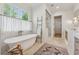 Bright bathroom features a freestanding tub, walk-in shower, and double vanity at 100 Maison Ct, Roswell, GA 30076