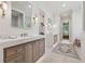 Bright bathroom featuring double vanities with stone countertops and modern fixtures, plus a decorative rug at 100 Maison Ct, Roswell, GA 30076