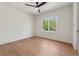 Bright bedroom boasts hardwood floors and a large window, providing ample natural light and a serene atmosphere at 100 Maison Ct, Roswell, GA 30076