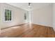 Bright bedroom features hardwood floors and two windows with nature views at 100 Maison Ct, Roswell, GA 30076