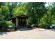 Picturesque covered bridge surrounded by lush greenery, offering a tranquil and scenic view in a wooded area at 100 Maison Ct, Roswell, GA 30076