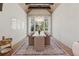Formal dining room featuring a modern chandelier, large windows, and designer accents at 100 Maison Ct, Roswell, GA 30076