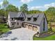 Stunning brick home featuring a three-car garage and a beautifully paved driveway at 100 Maison Ct, Roswell, GA 30076