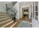Inviting foyer with a staircase and a glimpse into the open-concept living space at 100 Maison Ct, Roswell, GA 30076