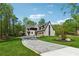 Beautiful home showcasing professional landscaping, a large lawn, and a circular driveway at 100 Maison Ct, Roswell, GA 30076