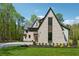 Exterior front of home with gray and white brick, green lawn and landscaping at 100 Maison Ct, Roswell, GA 30076