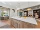 Island kitchen with marble countertop, sink, stainless steel appliances, and an open floor plan at 100 Maison Ct, Roswell, GA 30076