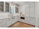 Well-lit kitchen with custom white cabinets, subway tile backsplash, and stainless steel appliances at 100 Maison Ct, Roswell, GA 30076