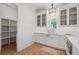 Elegant kitchen with white cabinets, stainless steel appliances, and adjacent pantry for extra storage at 100 Maison Ct, Roswell, GA 30076