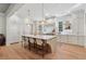 Bright, open kitchen features a large center island with counter seating and modern pendant lighting at 100 Maison Ct, Roswell, GA 30076