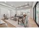 Bright living room featuring large windows, modern decor, and open access to the kitchen at 100 Maison Ct, Roswell, GA 30076