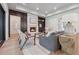 Elegant living room with a cozy fireplace, modern furniture, and plenty of natural light at 100 Maison Ct, Roswell, GA 30076
