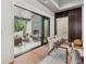 Stylish living room with sliding glass doors leading to an outdoor patio with a fireplace at 100 Maison Ct, Roswell, GA 30076