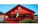The exterior of Mac McGee's Irish Pub, featuring flags at 100 Maison Ct, Roswell, GA 30076