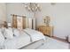 Spacious main bedroom with barn doors to bathroom, modern chandelier, and lots of natural light at 100 Maison Ct, Roswell, GA 30076