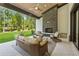Covered outdoor patio featuring a stone fireplace and comfortable seating area at 100 Maison Ct, Roswell, GA 30076